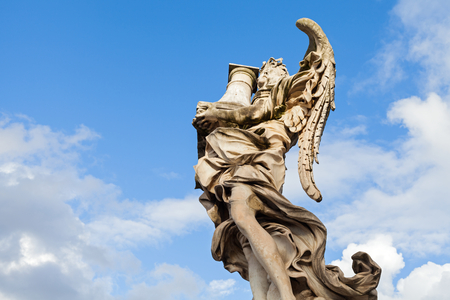 Beautiful sculpture in Rome, Italy against blue cloudy skyの写真素材