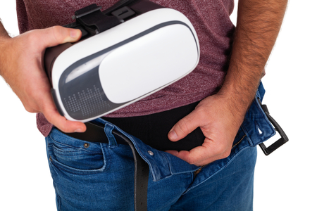 Picture of a  man holding his penis and a VR headsetの写真素材