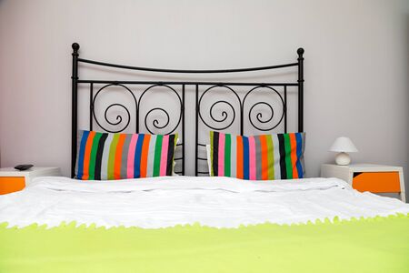 Colorful cozy bedroom in a modern apartment - booking accommodation