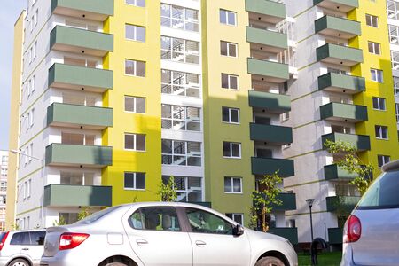 New apartment blocks with parking lot, parked cars outdoor - residential areaの写真素材
