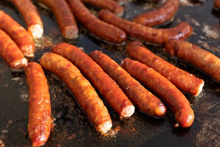 Homemade tasty fried pork sausages on a grillの写真素材