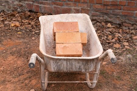 Close up picture of construction site. Bricks in a wheelbarrow