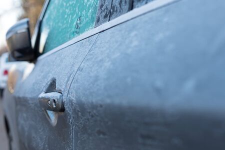 Frozen car parked on the street on Decemberの写真素材