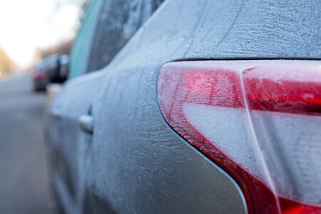 Frozen car parked on the street on December