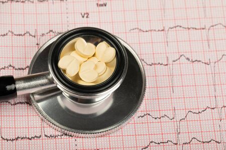 Electrocardiogram graph report with stethoscope on itの写真素材