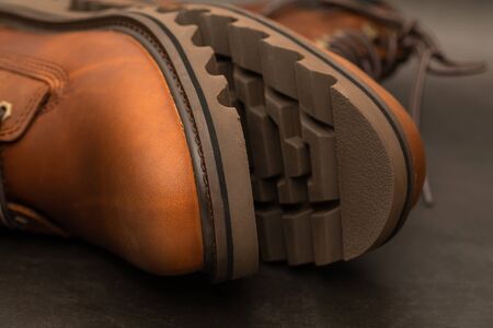 Brand new brown winter boots on gray backgroundの写真素材