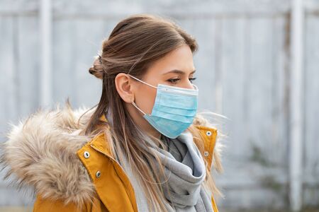 Portrait of young woman wearing protective mask - coronavirus pandemic alertの写真素材