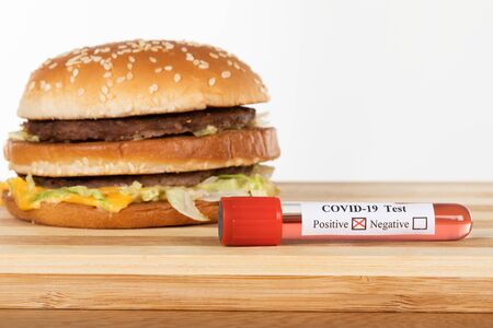 Home delivery burger in time of coronavirus quarantine - covid-19 blood test positive, social distancingの写真素材
