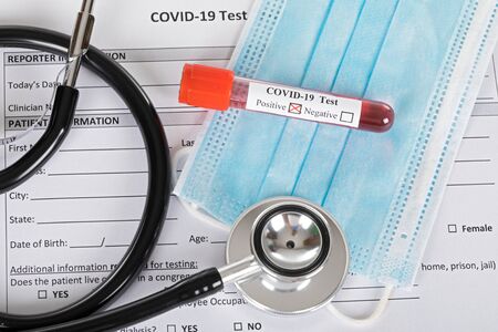 Covid-19 blood sample on wooden background - positive test