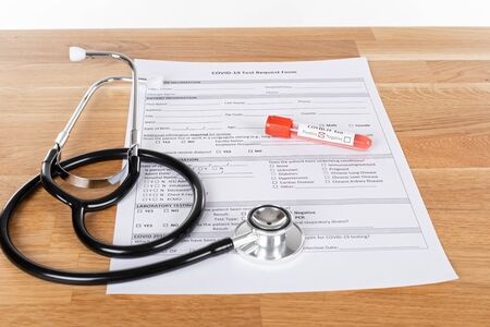 Close up picture of covid-19 blood test and medical supplies, pills on wooden background