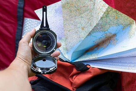 Close up picture of compass and map - preparing for camping trip in the woodsの写真素材
