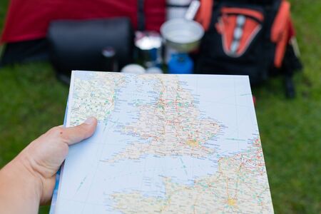 Picture of camping tools on the grass - backpack, tent, gas tank, cans, compass, etc - ready to go in the woodsの写真素材