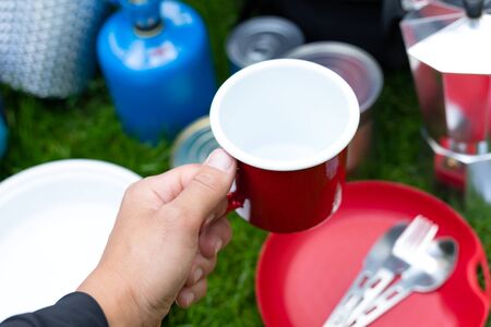 Picture of camping tools on the grass - backpack, tent, gas tank, cans, compass, etc - ready to go in the woodsの写真素材