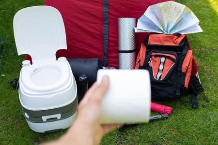 Picture of camping tools on the grass - backpack, tent, gas tank, cans, compass, etc - ready to go in the woodsの写真素材