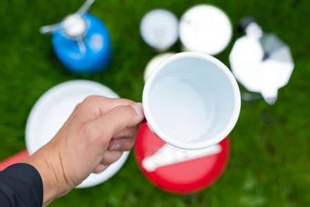 Picture of camping tools on the grass - backpack, tent, gas tank, cans, compass, etc - ready to go in the woodsの写真素材