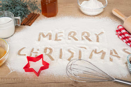 Merry Christmas text made with flour on wooden background - christmas compositionの写真素材