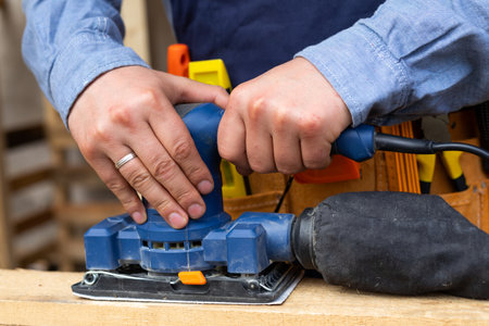 Close up picture of constructors hands holding house repairing suppliesの写真素材