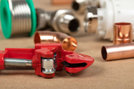 Objects of home heating system: brass valve, thermostatic valve, pipe cutter, copper plumbing partsの写真素材
