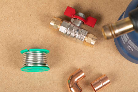 Objects of home heating system: brass valve, thermostatic valve, pipe cutter, copper plumbing parts