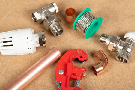 Objects of home heating system: brass valve, thermostatic valve, pipe cutter, copper plumbing partsの写真素材