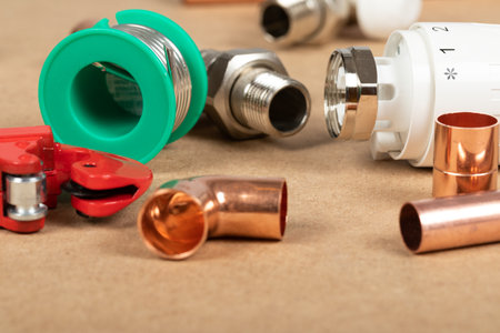 Objects of home heating system: brass valve, thermostatic valve, pipe cutter, copper plumbing partsの写真素材