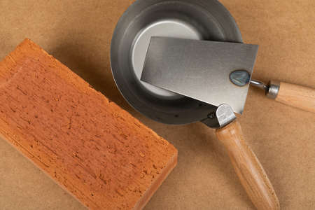 Picture of brick and mason tools on wooden background, top viewの写真素材
