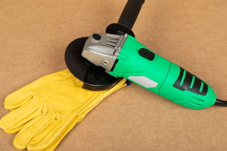 Picture of a green angle grinder on a wooden background