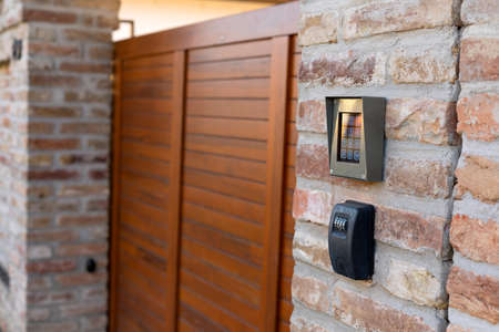 Door entrance with a modern door bell on the wall
