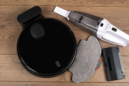 Picture of an automatic intelligent robotic vacuum cleaner with mop on the floorの写真素材