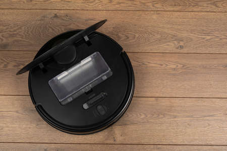 Picture of an automatic intelligent robotic vacuum cleaner  on the floorの写真素材