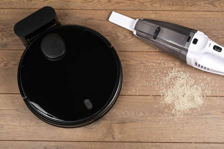 Picture of an automatic intelligent robotic vacuum cleaner with mop on the floor