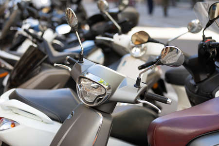 Picture of motorbike, motorcycle scooters parked in city streetの写真素材