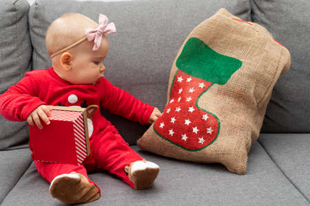 Picture of a happy baby playing with christmas gift boxの写真素材