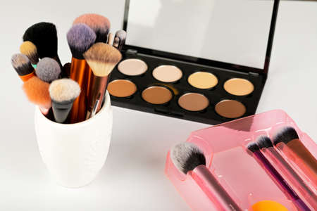 Close up picture of make up products and accessories, contour palette, brushes on white backgroundの写真素材