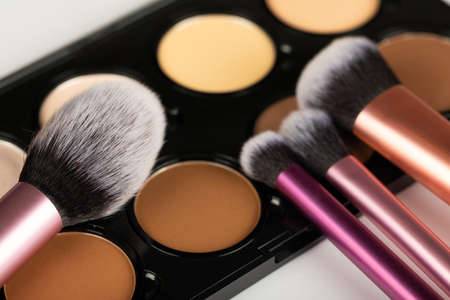 Close up picture of make up products and accessories, contour palette, brushes on white backgroundの写真素材