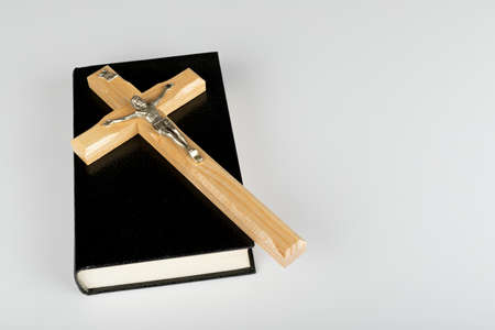 Holy Bible and cross on white background with copy spaceの写真素材