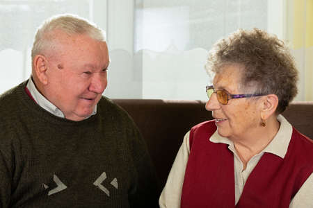 Picture of a joyful and happy elderly couple at home