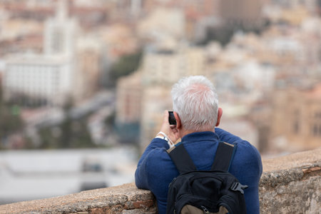 Old man taking picture in Malaga , Spainの写真素材