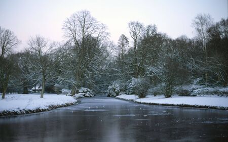 Frozen ditch in a snowy parkの写真素材