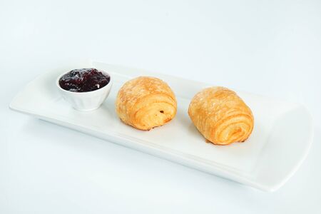 two fresh and tasty croissant over white backgroundの写真素材