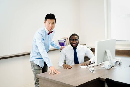 Two close Coworkers talking - multiple ethnicity - Boss and assistant の写真素材