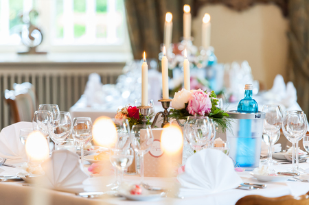 wedding table decoration with candles and flowersの写真素材