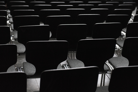 Rows ob black seats in conference room