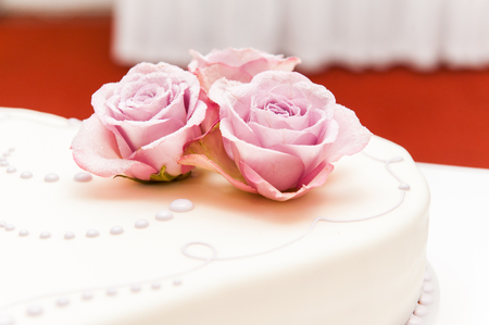 Pink roses made of sugar on wedding cakeの写真素材