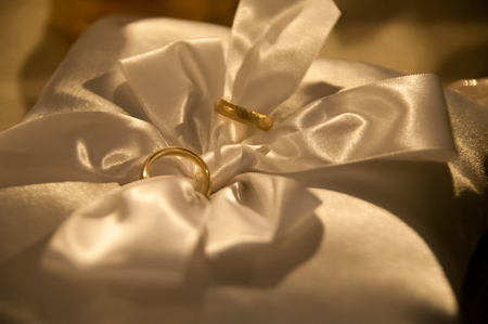 Wedding rings on satin pillowの写真素材
