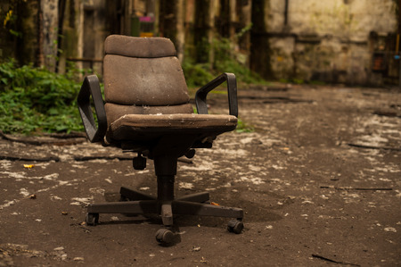 Bureau arm chair in abandoned industry hallの写真素材