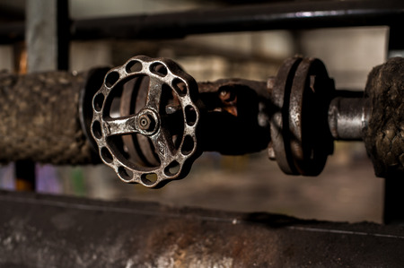 Metal wheel valve on industrial pipe