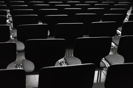 Rows ob black seats in conference roomの写真素材