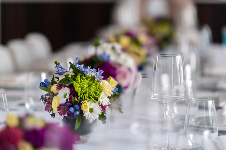 Party table with glasses and flowersの写真素材