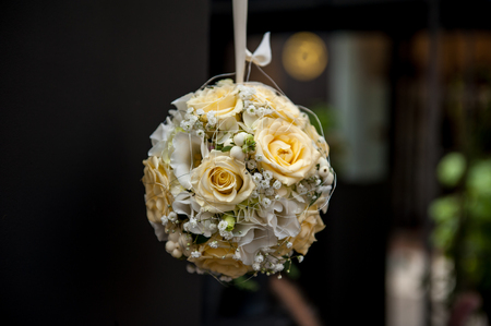 Sphere shape flower bouquet hanging on dark backgroundの写真素材